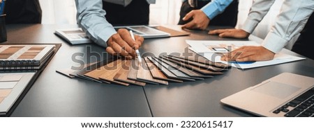 Group of interior designer team in meeting, discussing with engineer on interior design and planning for house project blueprint and model, choosing various mood board materials. Insight Royalty-Free Stock Photo #2320615417