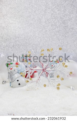 Christmas Card. Cheerful snowman and Christmas tree decorations. Winter background. High key  with shallow depth of field