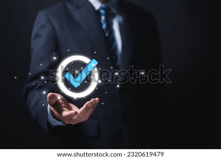 Businessman hand showing check mark digital technology icon symbol. Top quality assurance service concept, product performance assurance, and industry-leading ISO certification.
