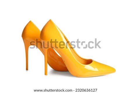 Pair of yellow high heeled shoes on white background Royalty-Free Stock Photo #2320636127