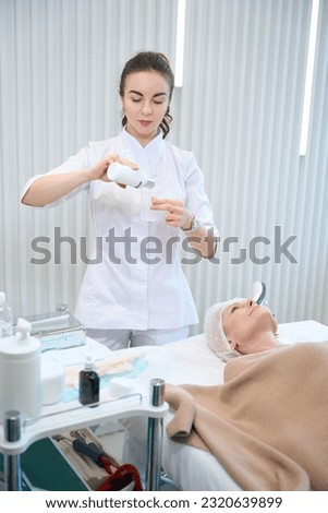 Beautician preparing for beauty procedure in cosmetologist office