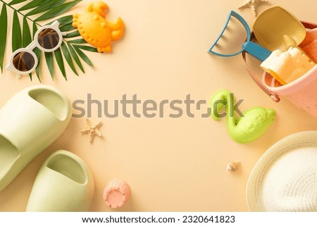 Relaxing beach retreat with baby. Top view of sand molds, sandcastle set, glasses, cap, rubber flip-flops, seashell, starfish, palm leaf against calming beige background. Great for text or ad purposes