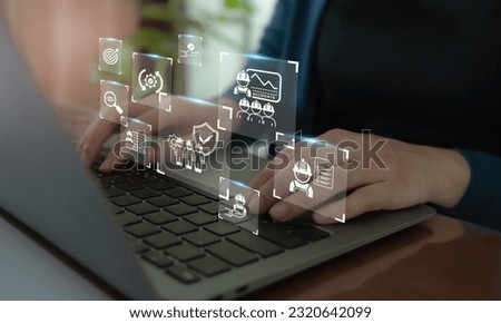 Work safety concept. Working on computer with icon of safety at workplace surrounded by safety first, protections, health, regulations and compliance. Working standard process. Zero accidents. Royalty-Free Stock Photo #2320642099