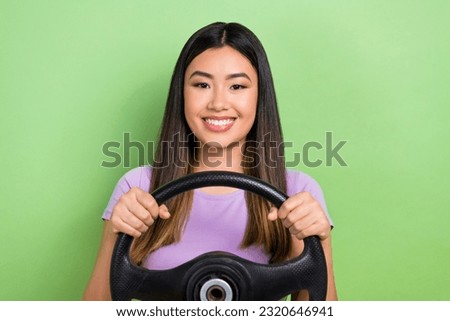 Photo of satisfied chinese girl hold steering wheel driving optimistic automobile no panic keep calm isolated on green color background