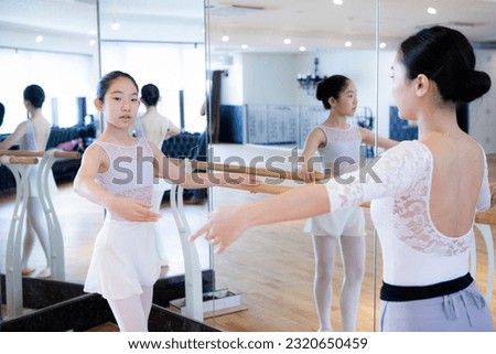 Ballerina girl taking ballet lessons