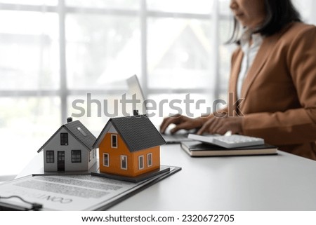 Real estate agent searching on laptop on project auction house to explain details to client and present information about home buying and mortgage, insurance, real estate trading concept.