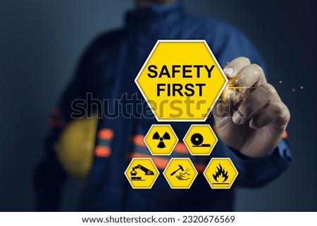 Safety first sign warning that deals with the health and safety of employees. icons and safety symbols and staff holding helmet to encourage about safety matter ISO 45001
