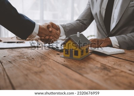 Real estate broker and client shaking hands after signing sale contract, home loan and congratulating insurance concept.