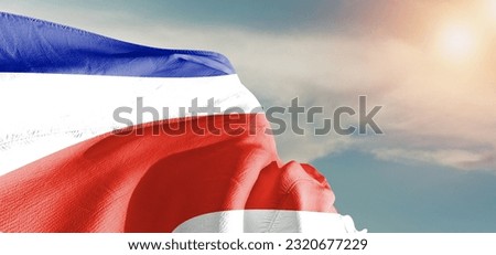 Costa Rica national flag cloth fabric waving on beautiful Cloudy Background.