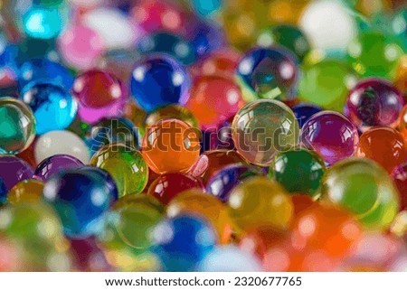 Water beads close-up, abstract background. Texture of Hydrogel balls or many colorful orbeez for wallpaper. Royalty-Free Stock Photo #2320677765