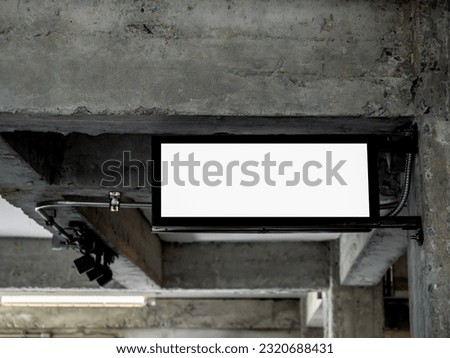 Hanging lightbox with blank space. Empty signage light box for advertising or sign, indoor. Sign board with black frame hanging on the ceiling near electric wiring steel pipes, loft style building.