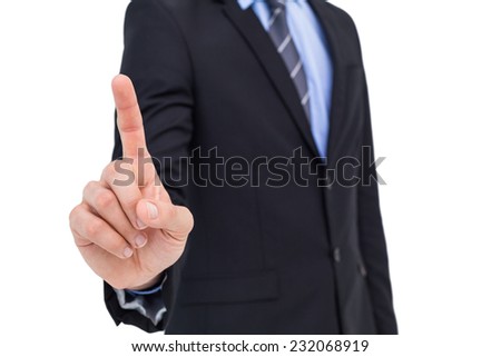 Mid section of businessman pointing something up on white background