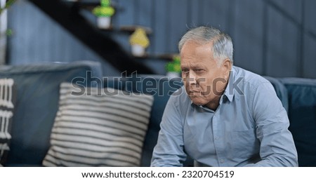 Worried retired senior man sitting alone on sofa feel sorrow abandoned anxiety at home. Unhappy Indian middle aged male grieving think lonely depressed pensive suffering health problems  Royalty-Free Stock Photo #2320704519