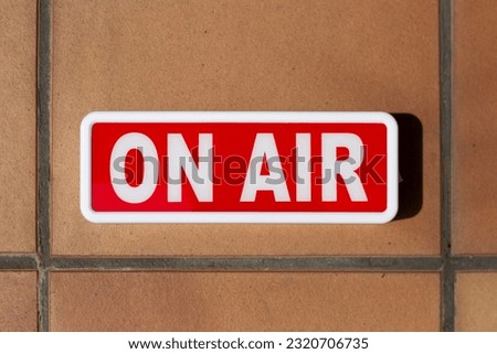 billboard signboard or indicator sign with the word "on air" written in white on a red background. on different surfaces. In a toilet Royalty-Free Stock Photo #2320706735