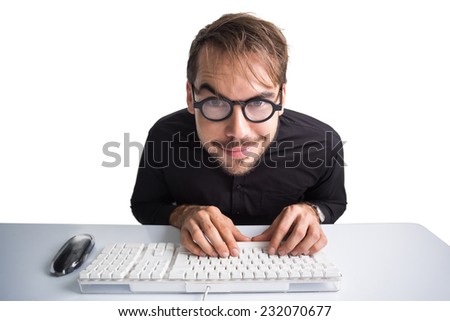 Excited businessman using computer and wearing glasses on white background