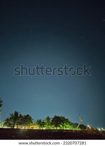 The clear night sky is filled with the light of the stars, which are taken from across the beach.