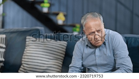 Worried retired senior man sitting alone on sofa feel sorrow abandoned anxiety at home. Unhappy Indian middle aged male grieving think lonely depressed pensive suffering health problems  Royalty-Free Stock Photo #2320719753