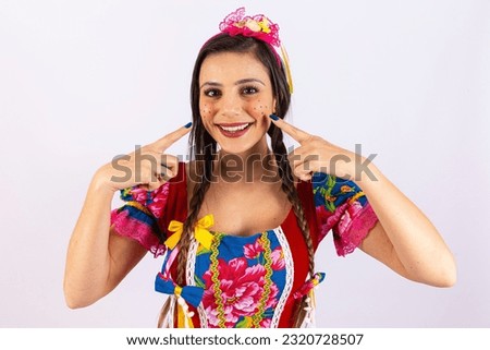 Young woman in typical clothes of famous Brazilian party called "Festa Junina" in celebration of São João.