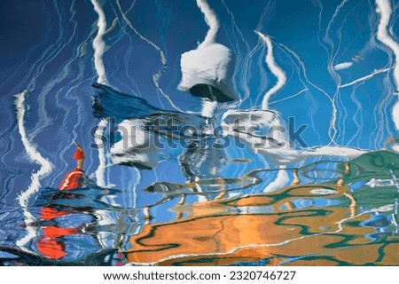 reflections on the blue sea sail boats and flag abstract background