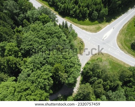 Aerial view of the road through the green forest. drone photography