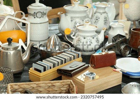 Many different stuff on black wooden table. Garage sale Royalty-Free Stock Photo #2320757495