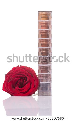 bright and colorful eye shadows stack on white background with white rose