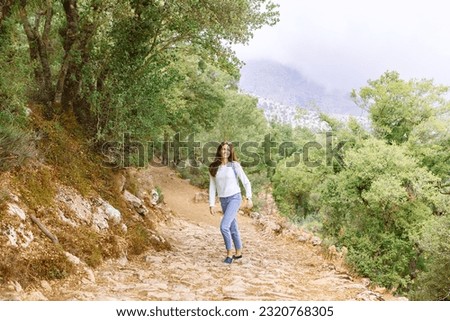 woman travels through the mountain gorge on a sunny summer day. banner, Crete, Greece