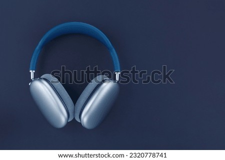 Headphones on blue background. Wireless blue headphones. AirPods max. Copy space Royalty-Free Stock Photo #2320778741
