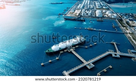 LNG (Liquified Natural Gas) tanker anchored in Gas terminal gas tanks for storage. Oil Crude Gas Tanker Ship. LPG at Tanker Bay Petroleum Chemical or Methane freighter export import transportation  Royalty-Free Stock Photo #2320781219
