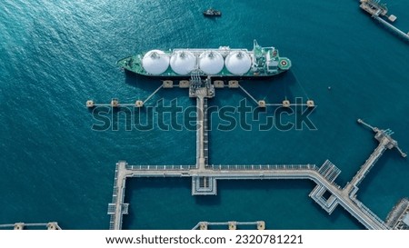 LNG (Liquified Natural Gas) tanker anchored in Gas terminal gas tanks for storage. Oil Crude Gas Tanker Ship. LPG at Tanker Bay Petroleum Chemical or Methane freighter export import transportation  Royalty-Free Stock Photo #2320781221