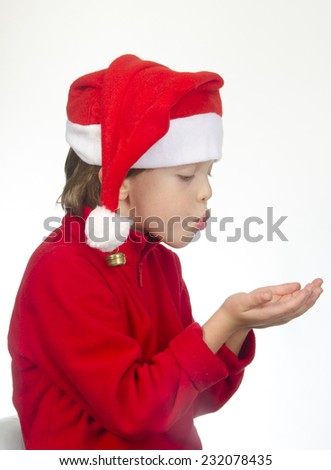 Little boy wearing Santa Claus uniform