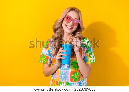 Photo attractive lady wonder movie film time start drink soda cup wear heart sunglass print shirt isolated yellow color background
