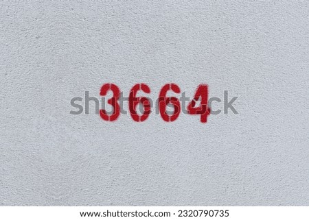 Red Number 3664 on the white wall. Spray paint.

