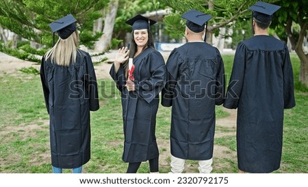 Group of people students graduated holding diploma saying hello with hand at university campus
