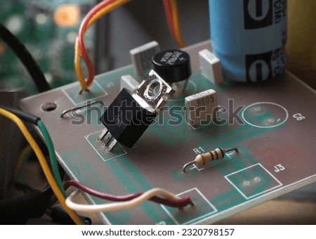 Simple voltage regulator circuit board. 5 Volts DC adapter powered by 7805 IC. Royalty-Free Stock Photo #2320798157