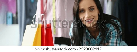 Positive female hairdresser communicates with male client in beauty salon