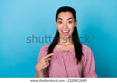 Portrait photo of young surprised korean woman pointing finger choose herself unexpected reaction isolated on blue color background