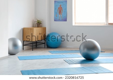 Interior of rehabilitation center with fitballs and mats Royalty-Free Stock Photo #2320816725