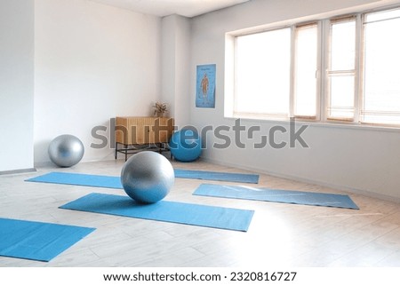 Interior of rehabilitation center with fitballs and mats Royalty-Free Stock Photo #2320816727