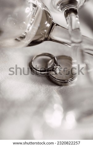 Ring Finger; the Engagement rings with the champange glass and white bed sheet shot on the macro lens.