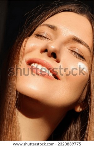 Beauty, suntan spf and skincare cosmetics model face portrait, woman with moisturising cream, sunscreen product or sun tan lotion on her cheek, luxury facial and skin care ad Royalty-Free Stock Photo #2320839775
