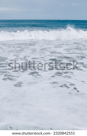 Textured sea foam. Wave on the beach