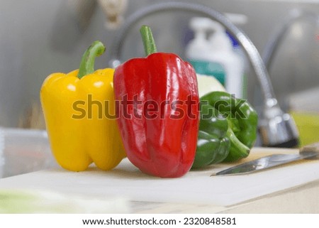 Sweet peppers, fresh in the kitchen, yellow, green, and red that have been cleaned, are ready to be cut, decorated, and used for cooking. Different menus, clear picture after blur, LED light.