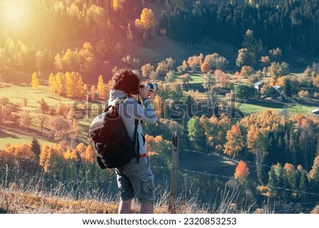 Young man traveler looking and photographing beautiful autumn in Turkey, Travel lifestyle concept.