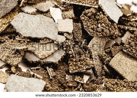 Manganese samples, flaked pure manganese metal used in industry, isolated white background. Royalty-Free Stock Photo #2320853629