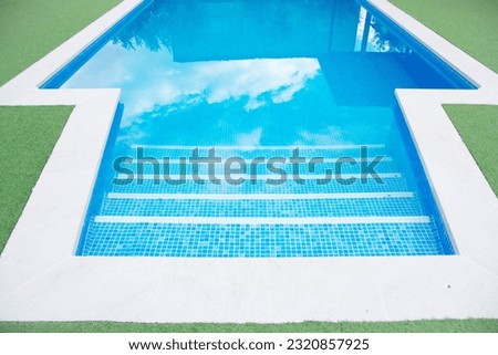 close up blue pool with green grass. copy space