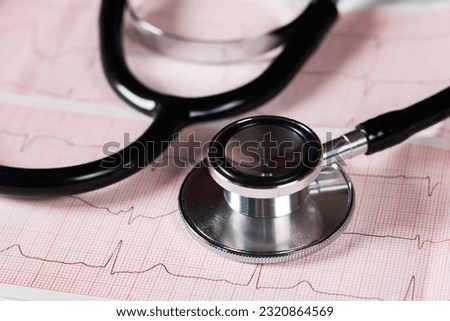 Medical concept. Cardiogram with stethoscope on table, closeup