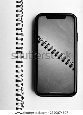 Spiral Notepad on desk with Mobile 
