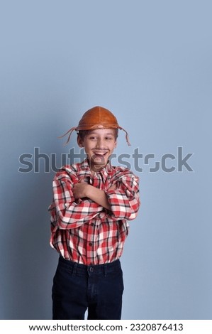 happy boy dressed as farm cowboy