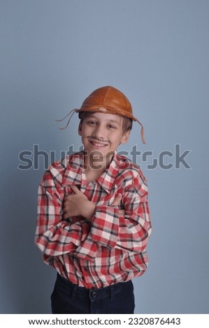 happy boy dressed as farm cowboy